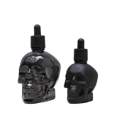 China 30ml 60ml Skull Dropper Bottle Luxury Matte Black Essential Oil Glass Bottle for sale