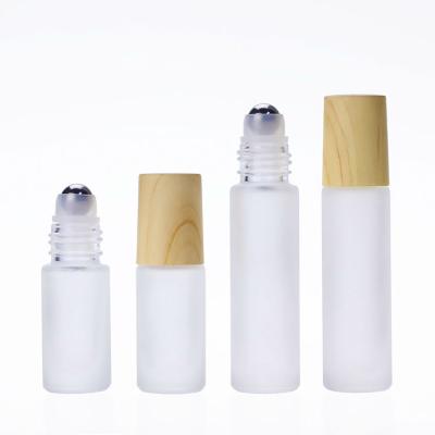 China Personal Care Frosted Bamboo Lid Roll On Glass Ball Perfume Bottle Essential Oil Roll On Bottle 5ml 10ml for sale