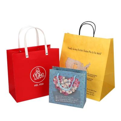 China Disposable custom luxury Kraft paper bags with handles /Chinese new year gift paepr bag for free sample for sale