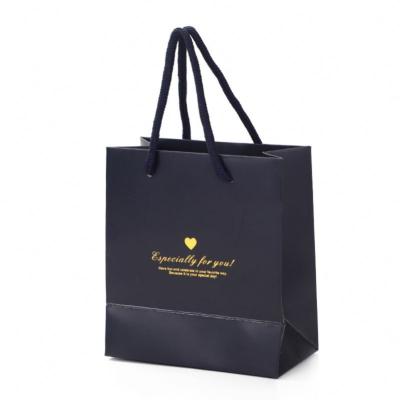 China Recycled Materials Shape New Design Black Luxury Paper Shopping Bag With Logo Hot Stamping In Gold Customized for sale