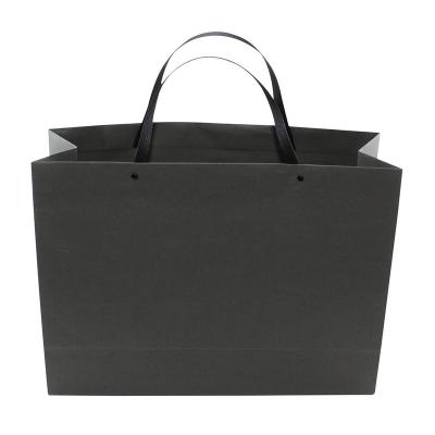 China Recyclable Art Coated Paper Bag With PP Handle OEM Luxury Custom Shopping Bag Black Hot Foiled Rope for sale