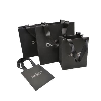 China Recyclable Custom Logo Printed Cardboard Paper Gift Jewelry Bag With Ribbon Handle for sale