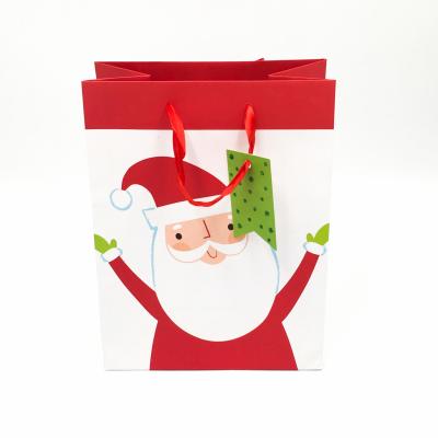 China Recyclable Fashion And Handmade Custom Printed Christmas Gift Paper Bag With Hang Tag for sale