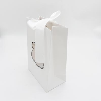 China Recyclable Custom Gold Ribbon Handle Gift Shopping Glossy Laminated Foil Paper Bag With Window for sale