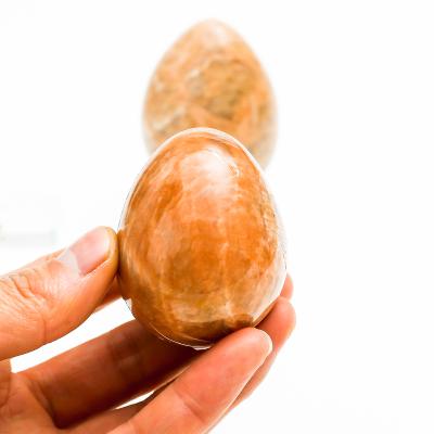 China Wholesale Natural Moonstone Red Egg Europe Reiki Gemston Crystal Egg Healing Quartz Crystal for sale