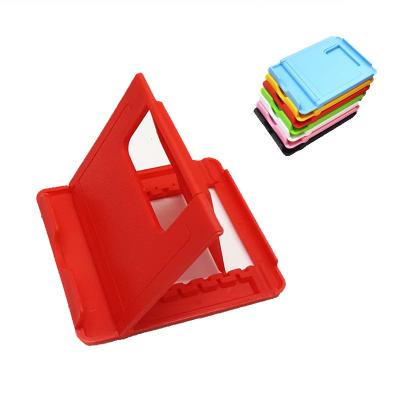 China 2021 Cheap Portable Mini Foldable Adjustable Plastic Mobile Stand For Desktop Tablet Cell Phone Lazy Stands for sale