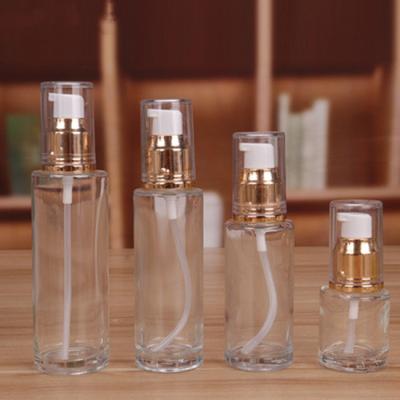 China Personal Care China Made 30ml 50ml Clear Round Glass Cosmetics Containers And Lotion Packaging Glass Bottles With Pump for sale