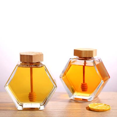 China Honey Factory Wholesale 220ml 380ml Hexagonal Shaped Honey Bee Storage Glass Jar with Wooden Dipper and Bamboo Lid for sale