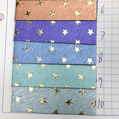 China Solid Anti-rust Gold Star Color Embossing Spunlaced Leatherette Backing For Making Patch Logo Badge Card Tag for sale