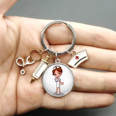 China Custom Design Suitable Creative Glass Nurses And Doctors Key Ring Pendant Gift Style Painting Fashion Nurse Medical Syringe Stethoscope Image Key Chain for sale