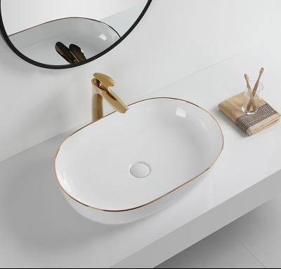 China Eco-Friendly Gold Line Bathroom Oval Ceramic Hand Wash Sink Countertops Wash Basin Modern Desgin for sale