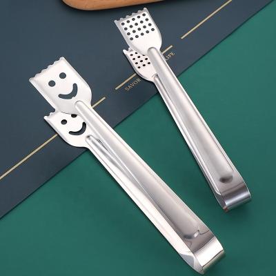 China Kitchen Use Smile Shape Stainless Steel Food Bread Tongs Food Procuring Grill BBQ Tongs for sale