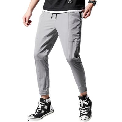 China Anti-Static Mens Big Stretch Drawstring Pants Sports Casual Straight Tube Loose Knitted Trousers Pants for sale