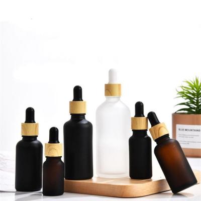 China TOSUN Clear Black Cosmetic Hot Frosted Amber Empty Glass Dropper Serum 5ml 10ml 15ml 20ml 30ml 50ml 100ml Bottles With Color Wooden Cap for sale