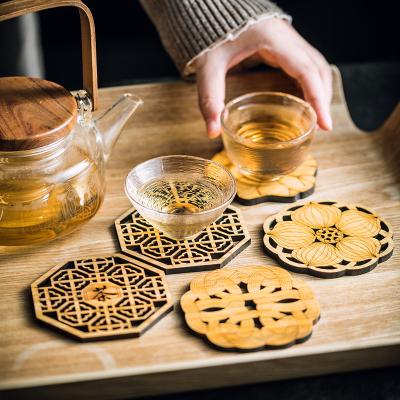 China Custom Hollow-Carved Bamboo Wooden Coasters Stocked Design Acacia Wood Mini Coaster Heat Insulated Pad for Tableware for sale