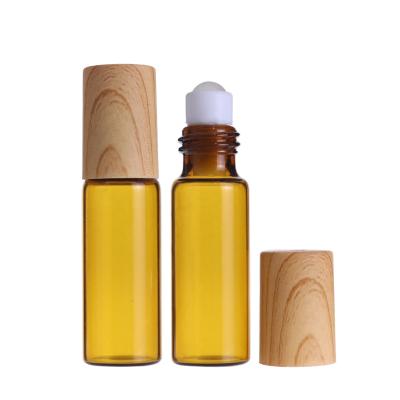 China Clear Amber 1ml 2ml 3ml 5ml 8ml 10ml High Quality Cosemtics Cylindrical Bottle Roll On Bottle With Bamboo Cap For Oud Perfume for sale