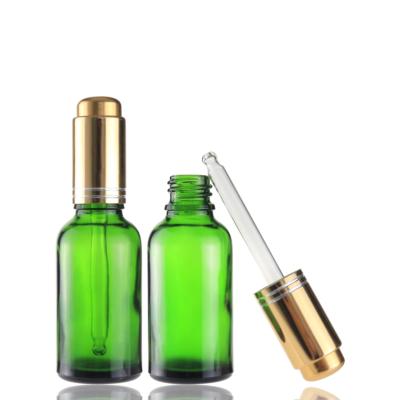 China Cosmetic Empty 30ml Dropper Green Glass Bottle With Press Pump Dropper For Hair Oil Argan Oil for sale