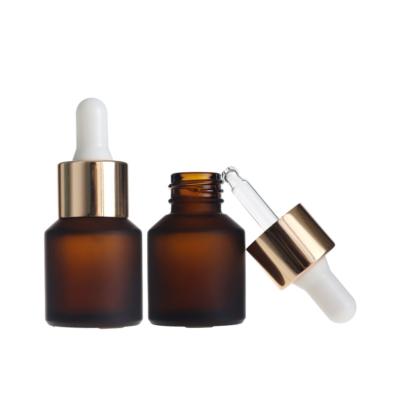 China Cosmetic Skin Care Packaging 15ml Slope Shoulder Essential Oil Amber Frosted Glass Bottle With Gold Dropper for sale