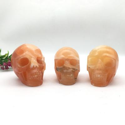 China China Wholesale Bulk High Quality Natural Orange Calcite Crystal Skulls For Decoration for sale