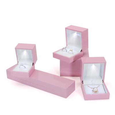 China Hot Handmade Custom Jewelry Boxes Ring Box Ring Bangle Pendant Logo Pink Color Plastic Jewelry LED Light for sale