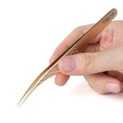 China Dolphin Stainless Steel Diamond Grip Eyelash Extension Tweezers Shape Gold Tweezers With PU Case for sale