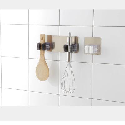 China Modern Universal Adhesive Wall Mounted Bathroom Kitchen Broom Holder Rack Brush Organizer Strong Broom Hooks for sale