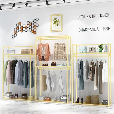 China New retail stores fashion store display furniture gold metal,clothes hanging with rack/gold set clothes display for sale