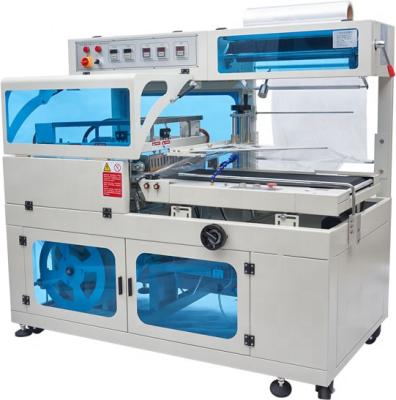 China Fully automatic low price L type shrink tunnel shrink wrap machine automatic shrink wrap food machine for sale