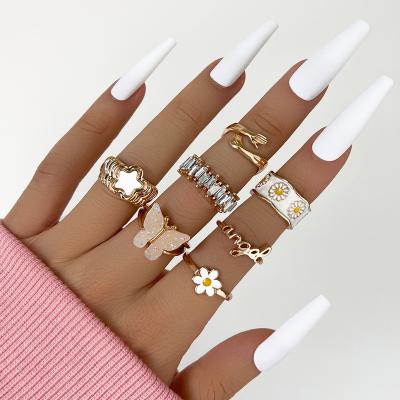 China Soft White Alloy Enamel Daisy Embrace 7 Pcs Set Rings Multiple Shapes Butterfly Crystal Acrylic Rings for sale