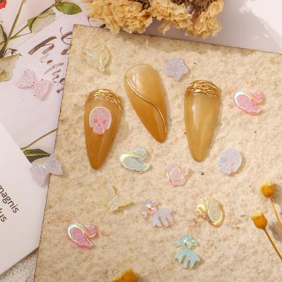 China Eco-friendly Material Luminous Swan Fox Butterfly Manicure Star Crown Five-pointed Goldfish Skull Painted Mixed Color Animals To Nail Drill Ornaments for sale