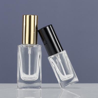 China Cosmetic Clear glass perfume bottle 50ml cylinder transparent perfume spray gold black lid for sale