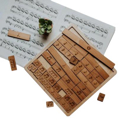 China Wooden Educational Toy Montessori Musical Puzzle Toys Art Note Jigsaw Tangram Cognitive Cartoon Learning Toys For Kids Split Tiles for sale