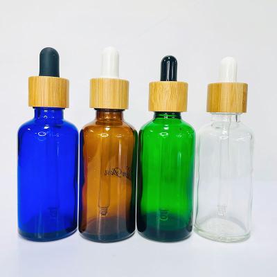 China Empty Frosted Amber Green Glass Personal Care Cosmetic Packaging Containers Oil Bottle With Pump Dropper Spray Bamboo Lid for sale