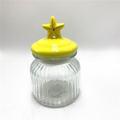 China Christmas Organization 650ml Ribbed Glass Food Storage Jar With Yellow Star Shaped Ceramic Lid For Christmas Home Food Organization for sale