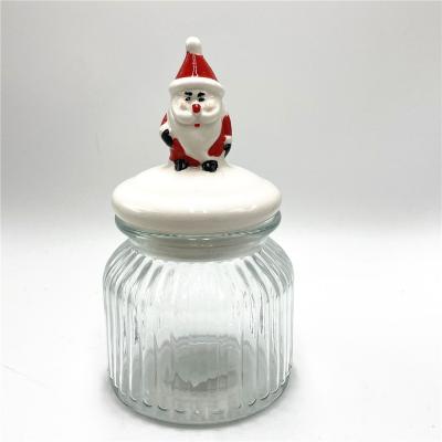 China Hot Sale Christmas Organization 650ml Ribbed Glass Food Storage Jar with Santa Claus Ceramic Lid for Christmas Home Organization for sale