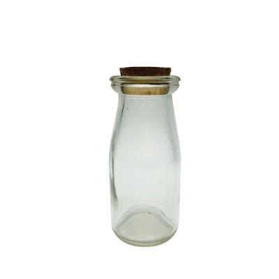 China Cheap Stocked 100ml Clear Tall Clear Pudding Yogurt Glass Jar With Cork Lid Glass Jar For Milk Cake Jelly for sale