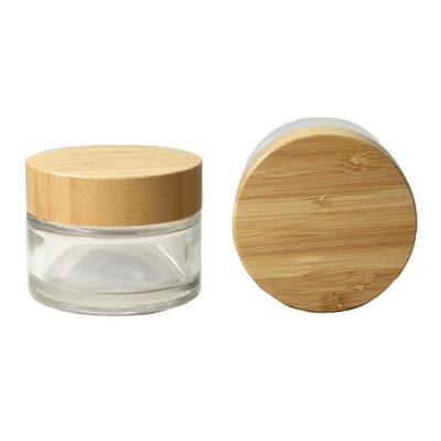 China Empty cosmetic jar 30g 50g 100g clear glass jar cosmetic jar with bamboo lid in stock for sale