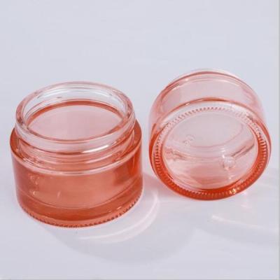 China 50g 100g cosmetic glass jar stock color pink rose gold cosmetic jar with lid for sale