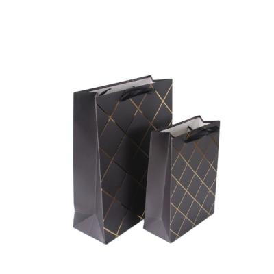 China 2020 New Recyclable Gold Stripe Luxury Paper Bag With Ribbon Handles Birthday Wedding Party Black Gift Bag for sale