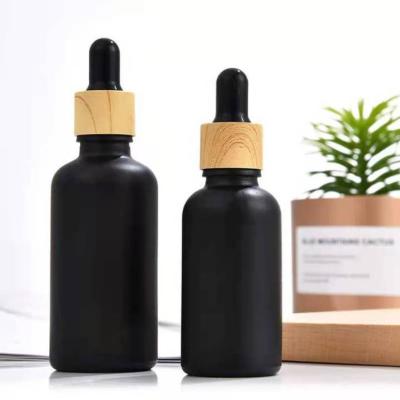 China 30ml 50ml 100ml Cosmetic Custom Matte Black Essential Oil Bottle Frosted Travel Glass Cosmetic Bottle for sale