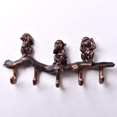 China Luxury Wholesale Morden Monkey Resin Clothing Rack Coat Wall Hanger Hook For Living Room Decoration for sale