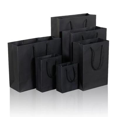 China Custom Luxury Matte Handled Black Shopping Paper Bag With Logo For Apparel Packaging for sale