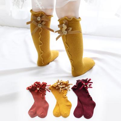 China Spring and autumn bow socks solid color children's QUICK DRY border socks with ears cartoon lace baby wooden socks for sale