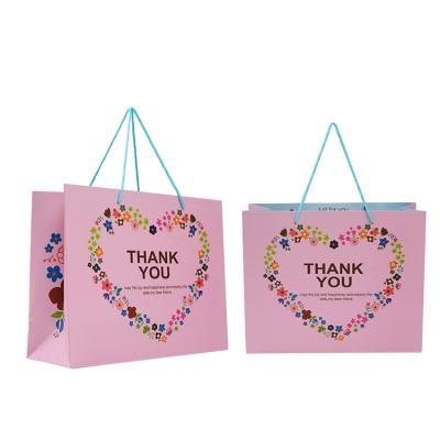 China Recyclable Paper Bag Apparel Packaging Personalized Paper Bag Rope Handle Matte Pink Shopping Gift Packaging Paper Bag for sale