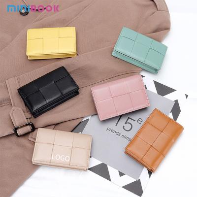 China Material de tejido cartera corta para mujeres piel de oveja de verdadera piel de cerradura de moneda bolso de moda femenina clip de dinero en venta