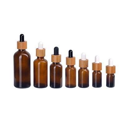 China Non Spill 5ml 10ml 15ml 20ml 30ml 50ml 100ml amber essential oil serum glass dropper bottle with bamboo cap for sale