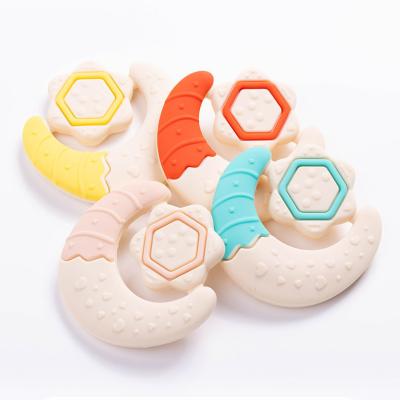 China Brinquedos de dentição personalizados de bebê Estrela de forma de lua de mão agarre de silicone agarre de dente para bebês à venda