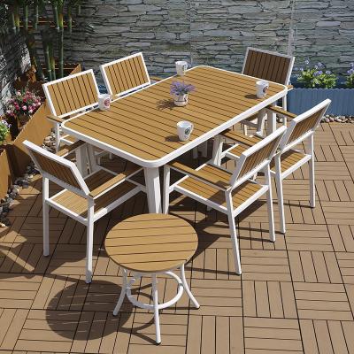 China Modern Outdoor Waterproof Dining Plastic Wood Tables And Wood Color Chairs for sale