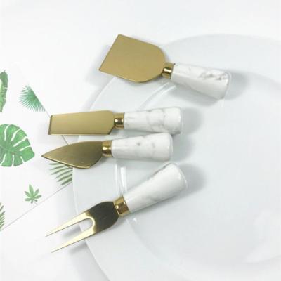 China Sustainable New Four-piece Set Marble Pattern Ceramic Cheese Handle Gold Plated Stainless Steel Cheese Knife for sale