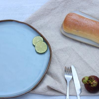 China Simple Design Disposable Irregular Rim Round Handmade Ceramic Serving Tray Large Dish With Reactive Glaze for sale